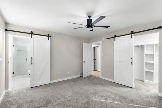 a view of a big room with closet and a ceiling fan
