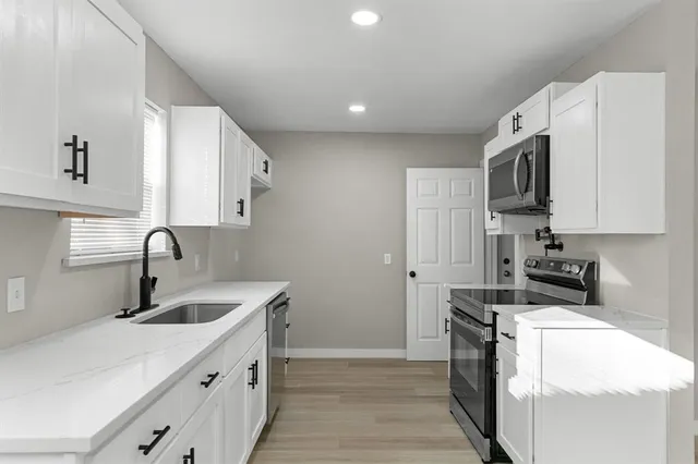 a kitchen that has a sink and a stove