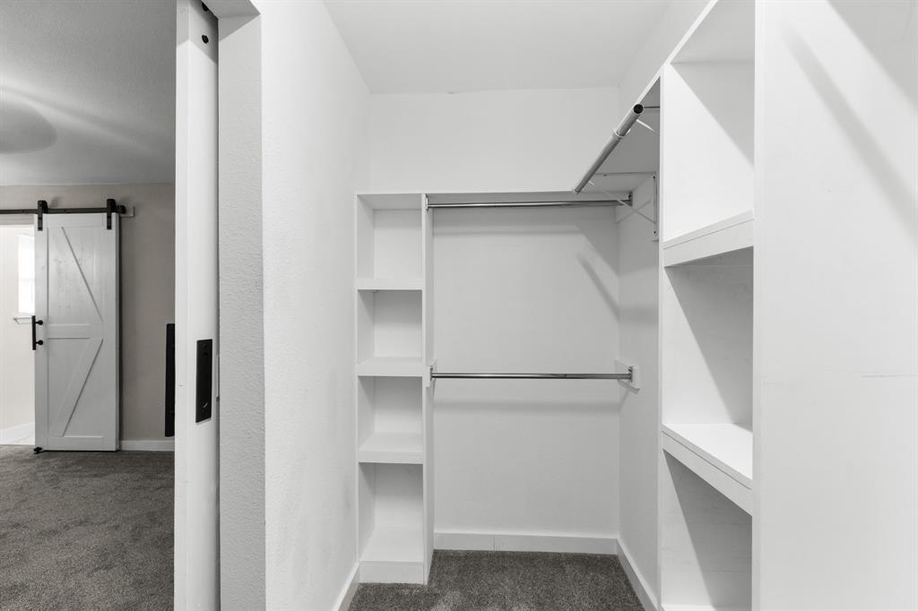 1002 Wembley Road Arlington, TX 76014 - Photo 8 of 20 a view of walk in closet with empty racks