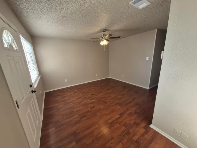 wooden floor in an empty room with a mirror