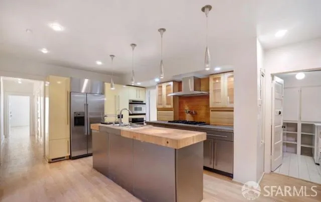 a kitchen with stainless steel appliances a refrigerator sink and microwave