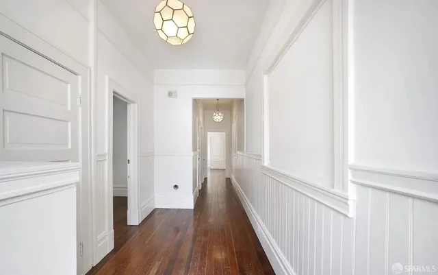 a view of an entryway with wooden floor