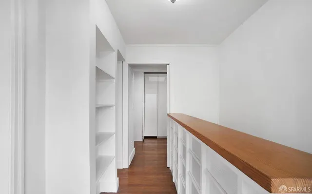 a view of a balcony with wooden floor and door