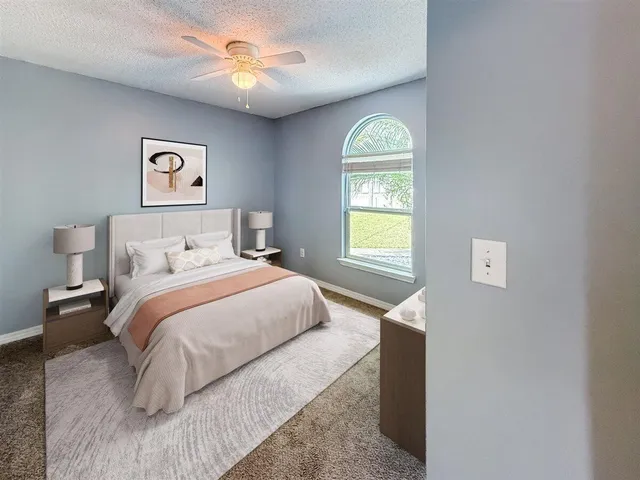 a bedroom with a bed and a window