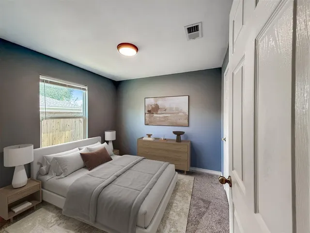 a bedroom with bed and a window