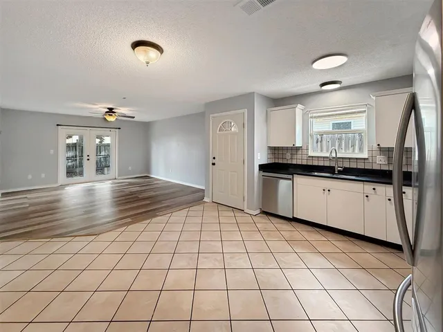 a kitchen with granite countertop a sink and cabinets