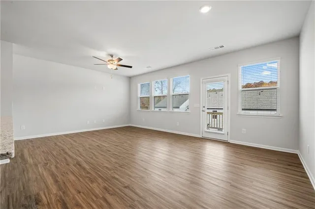 wooden floor in an empty room with a window