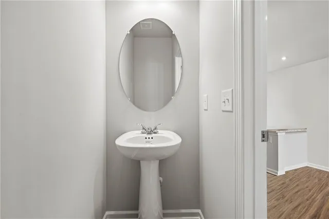 a bathroom with a sink a mirror and shower