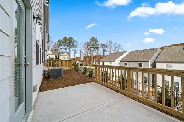 a view of a balcony with couches and wooden floor