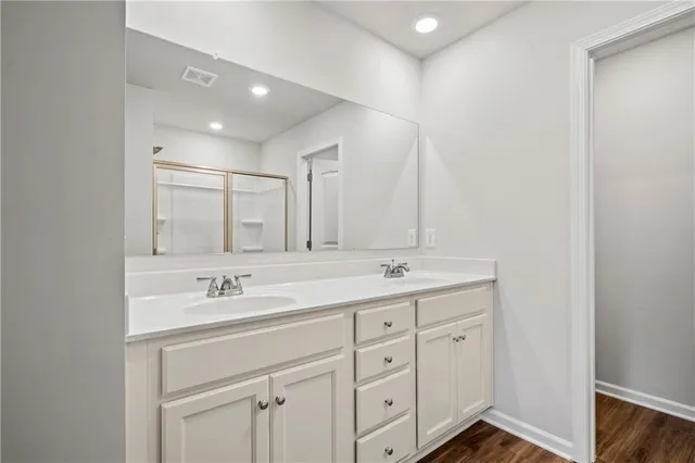 a bathroom with a double vanity sink and mirror