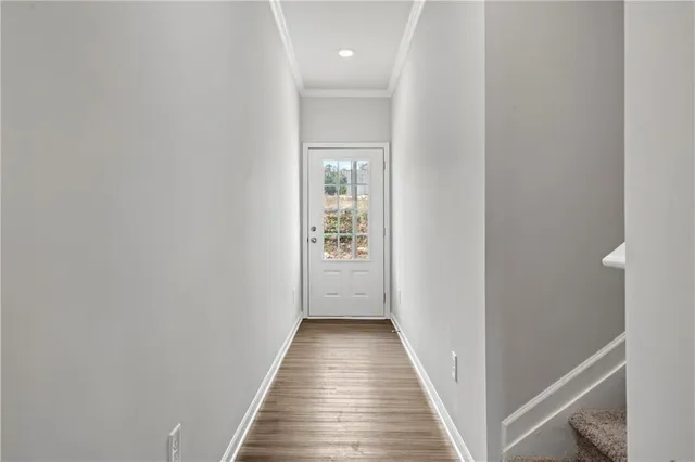 a view of a hallway with wooden floor