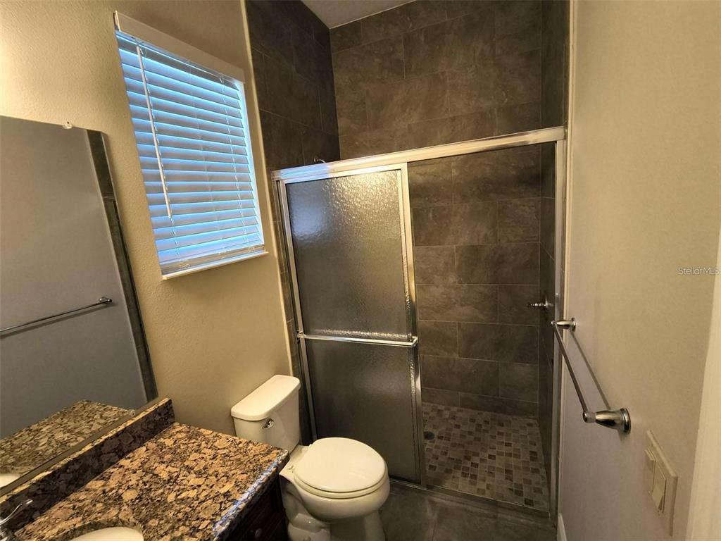 13 Wood Amber Lane, Unit B Palm Coast, FL 32164 - Photo 2 of 7 a bathroom with a toilet and a shower