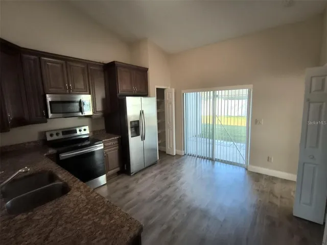 a kitchen with a refrigerator an oven