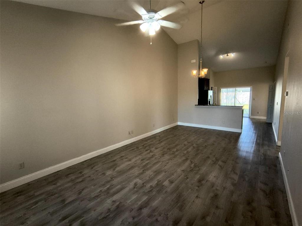 13 Wood Amber Lane, Unit B Palm Coast, FL 32164 - Photo 5 of 7 an empty room with wooden floor and windows