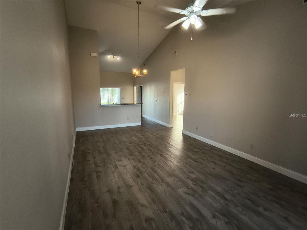 13 Wood Amber Lane, Unit B Palm Coast, FL 32164 - Photo 6 of 7 an empty room with wooden floor and windows