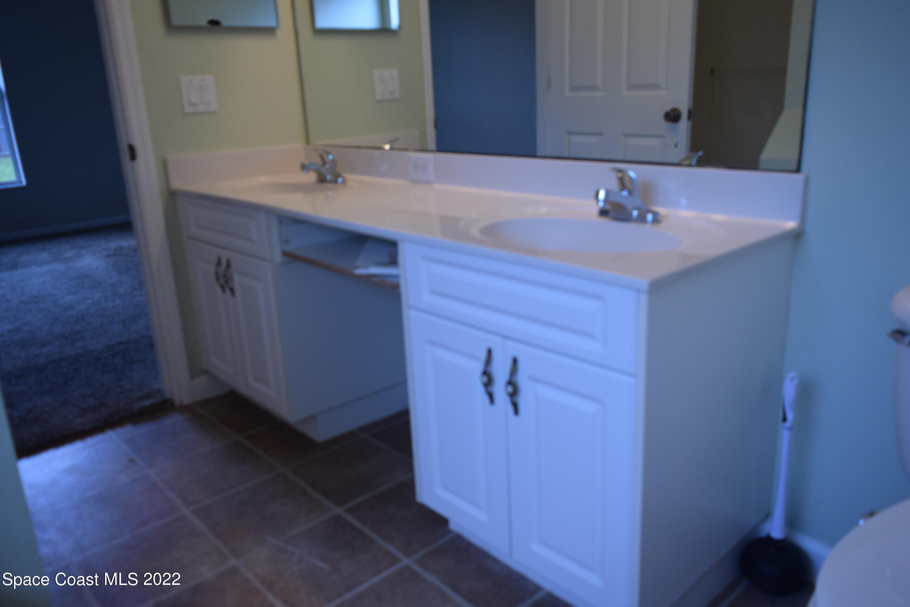 271 Titan Road Southeast Palm Bay, FL 32909 - Photo 14 of 22 a bathroom with a sink and a mirror