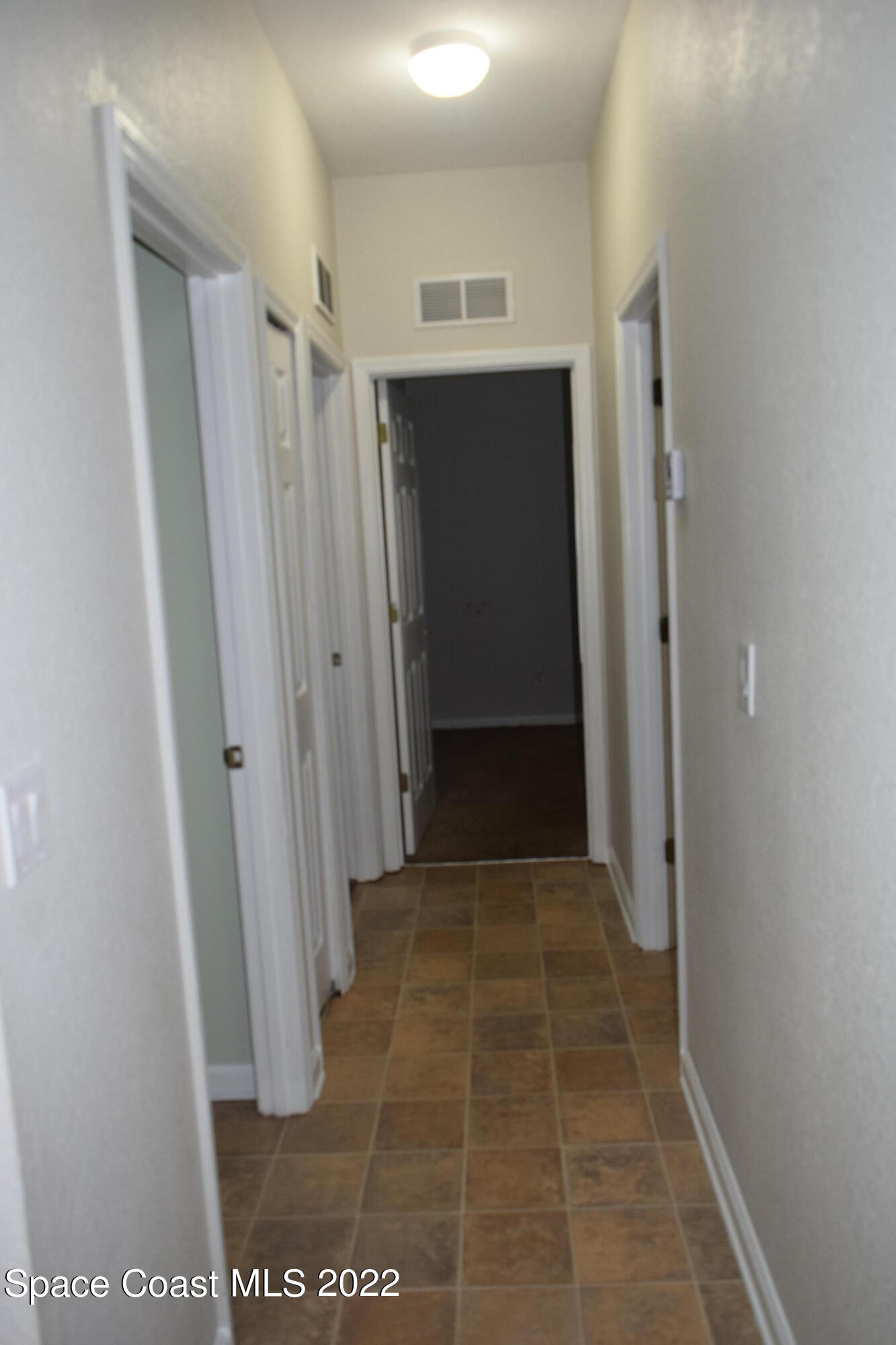 271 Titan Road Southeast Palm Bay, FL 32909 - Photo 16 of 22 a view of hallway with walk in closet and wooden floor