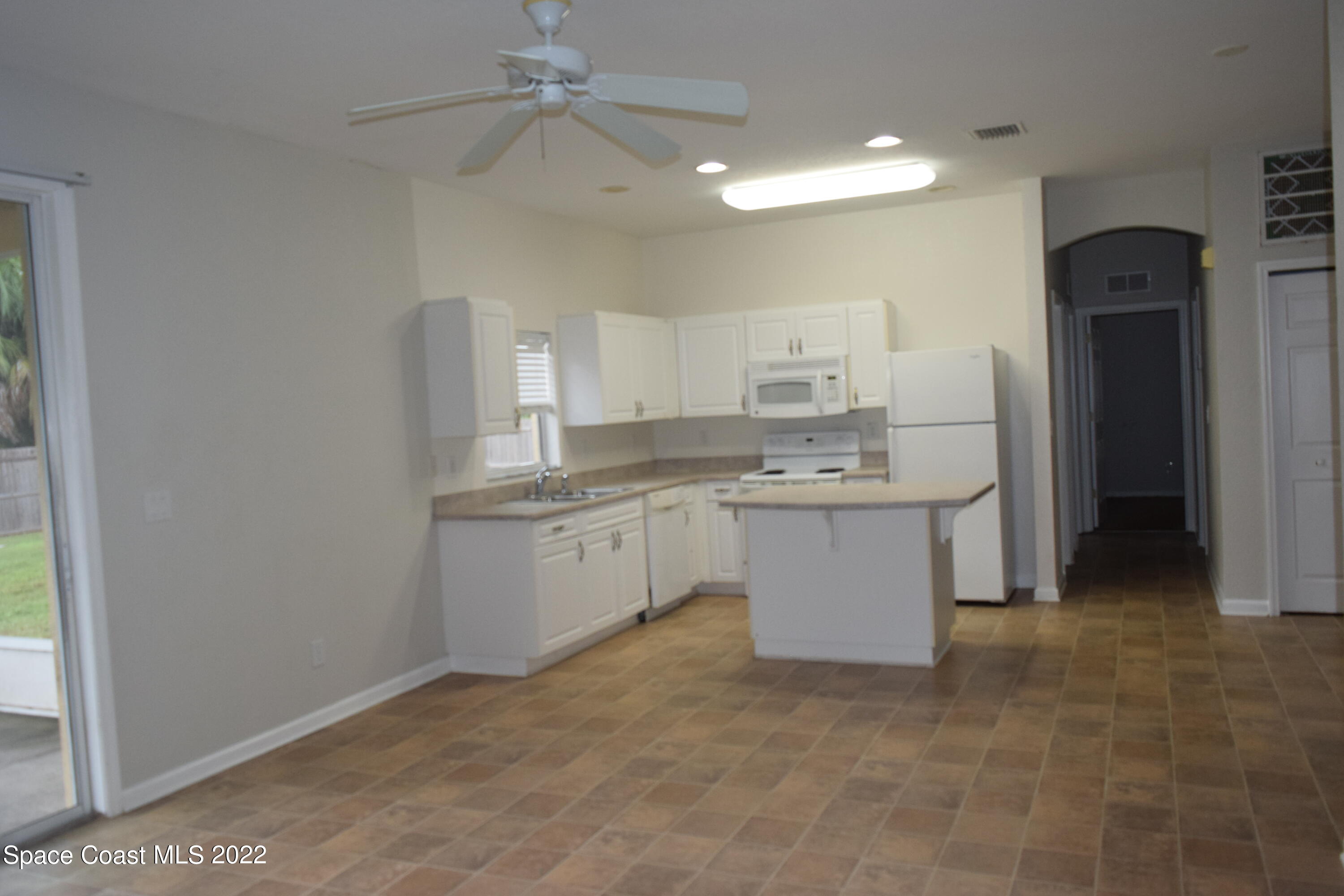 271 Titan Road Southeast Palm Bay, FL 32909 - Photo 5 of 22 a kitchen with a sink cabinets and window