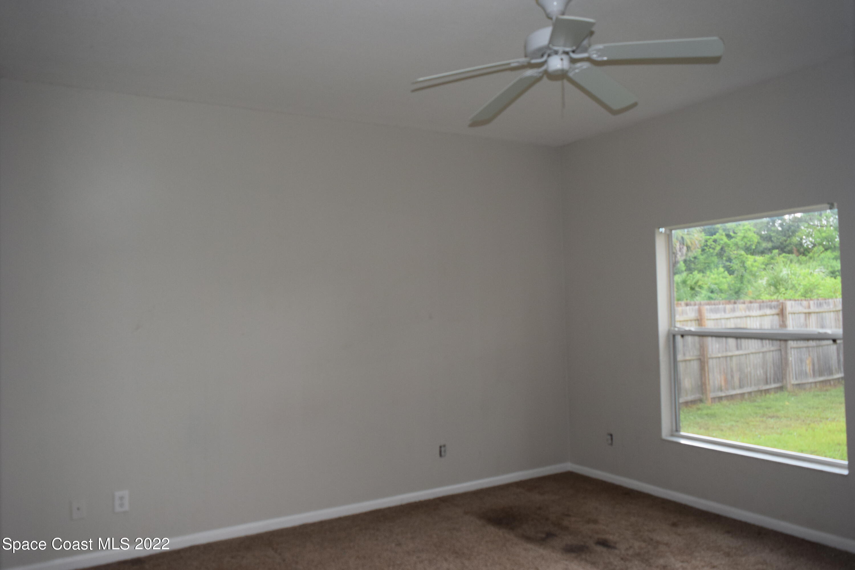 271 Titan Road Southeast Palm Bay, FL 32909 - Photo 8 of 22 an empty room with a window