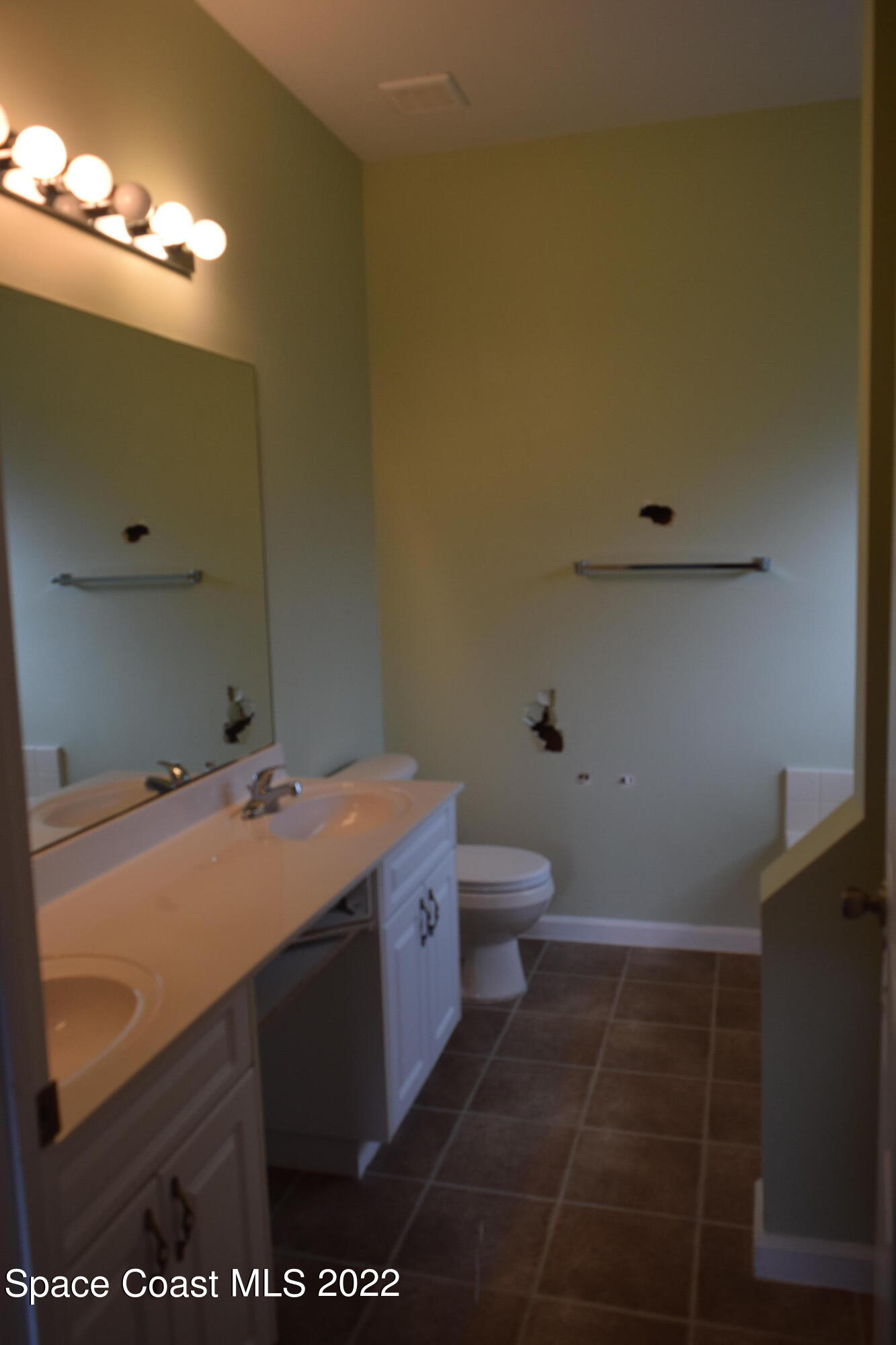 271 Titan Road Southeast Palm Bay, FL 32909 - Photo 10 of 22 a bathroom with a sink and a toilet