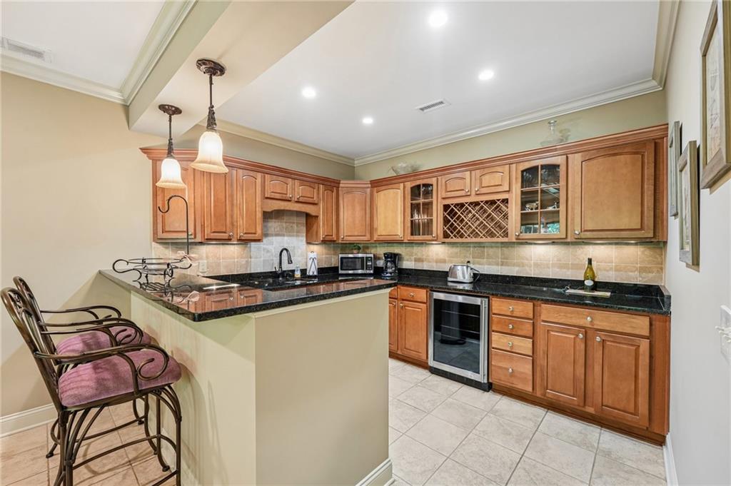 189 Red Trillium Ridge Big Canoe, GA 30143 - Photo 58 of 98 a kitchen with stainless steel appliances granite countertop a stove top oven a sink dishwasher a dining table and chairs with wooden floor
