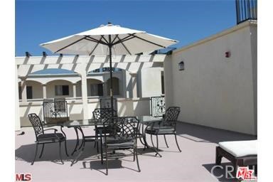 11848 Kiowa Avenue, Unit 101 Los Angeles, CA 90049 - Photo 2 of 11 a table and chairs in patio