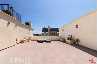 a living room with furniture a chandelier and a rug