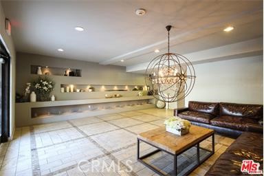 11848 Kiowa Avenue, Unit 101 Los Angeles, CA 90049 - Photo 6 of 11 a living room with furniture a chandelier and a rug