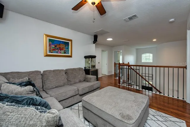 a living room with furniture and kitchen view