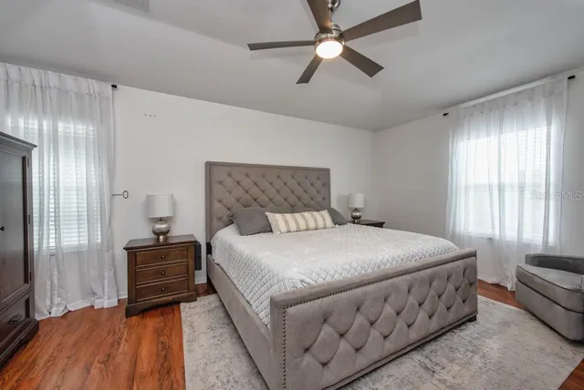 a bedroom with a bed and a chandelier
