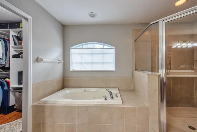 a bathroom with a bathtub and a shower