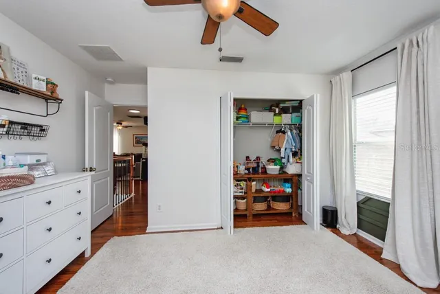 a bathroom with a granite countertop double vanity sink mirror bathtub and toilet
