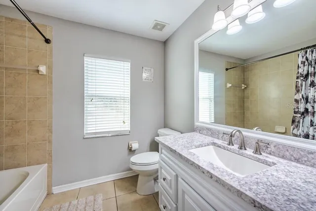 a view of a backyard with lawn chairs