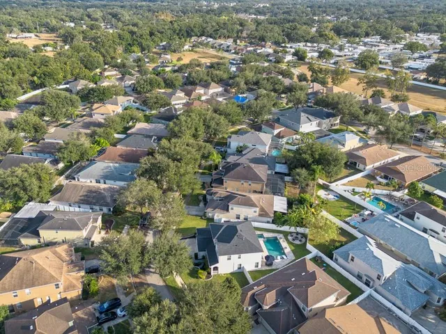 an aerial view of residential houses with outdoor space and street view