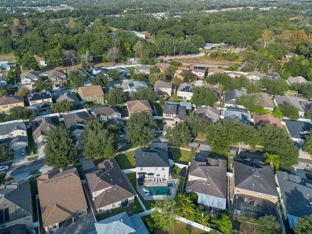 an aerial view of residential houses with outdoor space