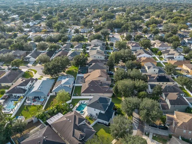 an aerial view of a house with garden space and street view