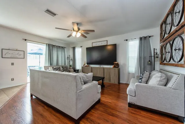 a living room with furniture and a flat screen tv