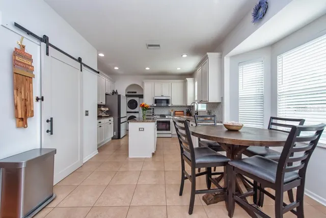 a view of kitchen with cabinets table and chairs