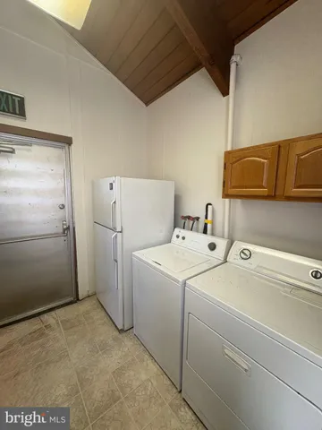 a bathroom with a granite countertop shower and a sink