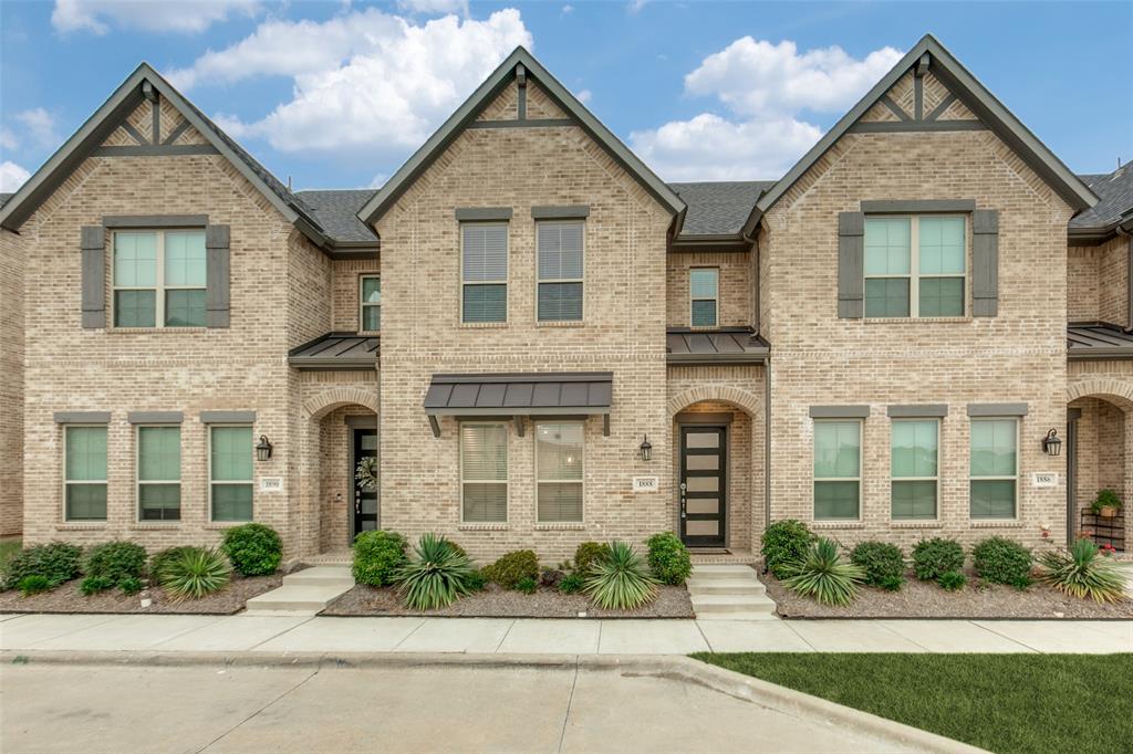 1888 Strand Street Dallas, TX 75234 - Photo 1 of 13 Contemporary townhome exterior featuring light-colored brick masonry and dark-toned gables