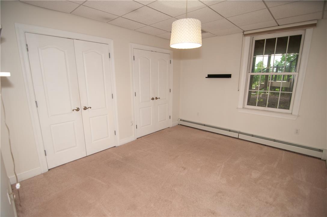 2202 High Meadow Road Coopersburg, PA 18036 - Photo 36 of 41 Plush carpeting and paneled double doors anchor this versatile space featuring a grid ceiling.