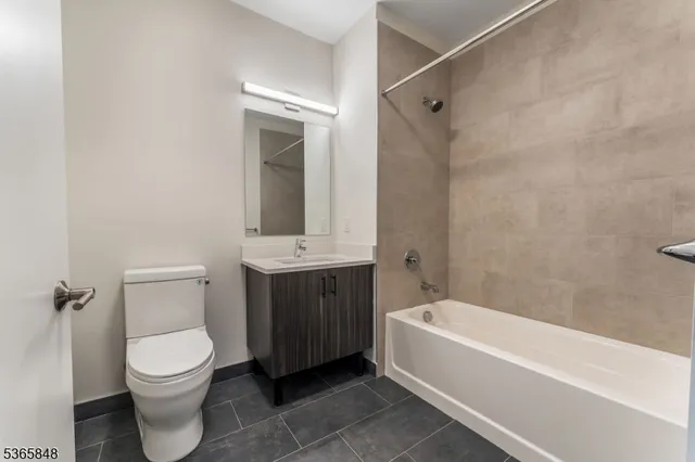 a bathroom with a toilet a sink and bathtub