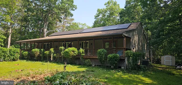 a front view of house with a garden