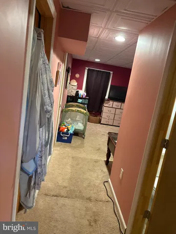 a bedroom with a bed and a tv