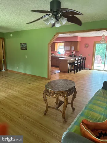 a dining room with furniture and a floor to ceiling window
