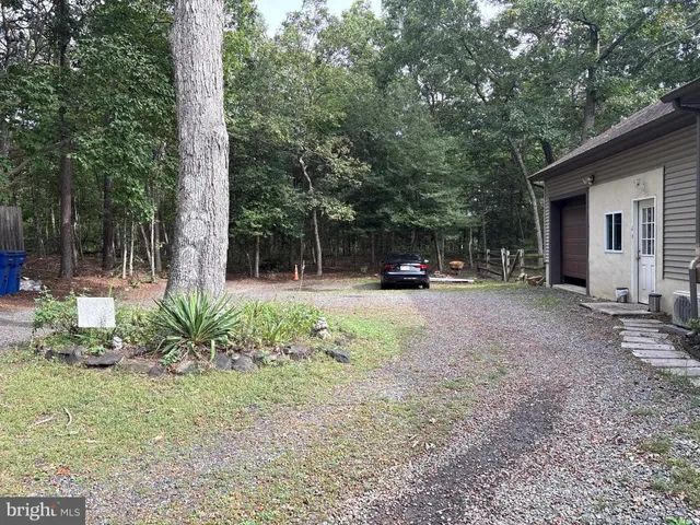 a view of a house with garden and a sitting area
