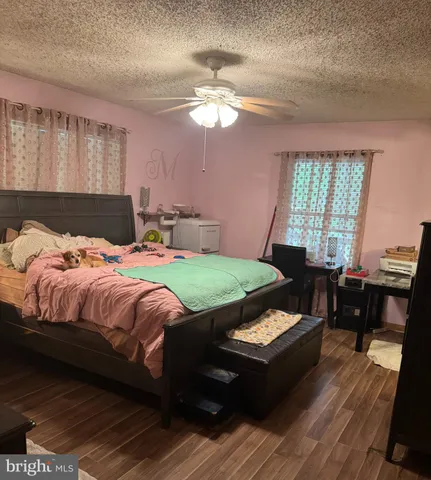 a bedroom with a bed window and a table