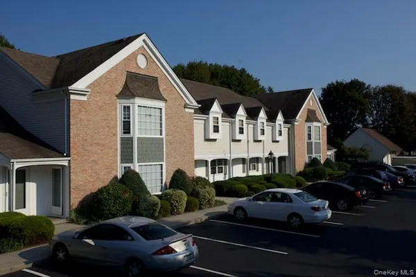 a view of a white house with a yard