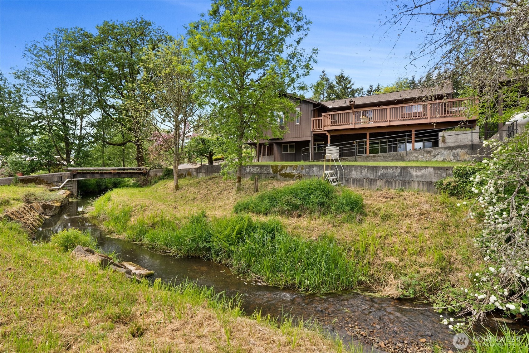 a backyard of a house with a yard table and chairs
