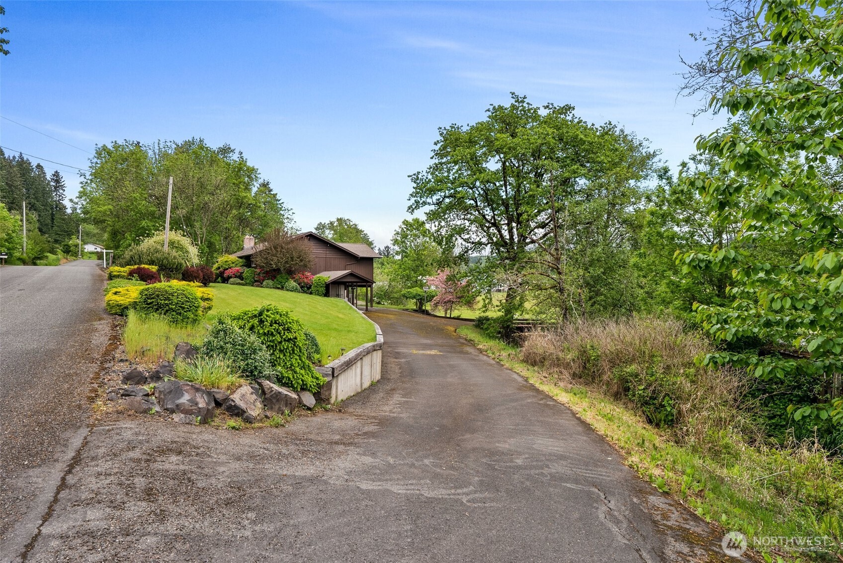 154 Sanderson Road Chehalis, WA 98532 - Photo 27 of 27 a view of a garden with a bench in front of it